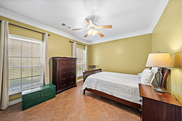 bedroom featuring light tile patterned flooring, visible vents, crown molding, and a ceiling fan