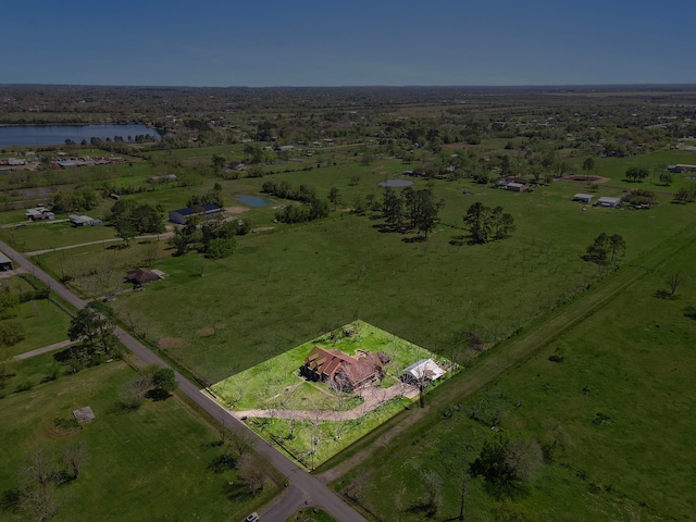 birds eye view of property with a water view and a rural view