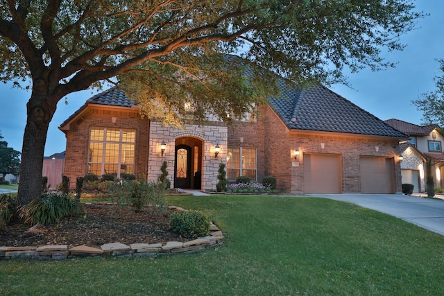 15614 Lake Iris Dr, Houston, TX 77070 - view of front facade featuring brick siding, a front yard, concrete driveway, a garage, and a tiled roof