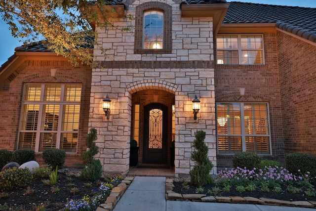 15614 Lake Iris Dr, Houston, TX 77070 - entrance to property featuring a tile roof, stone siding, and brick siding