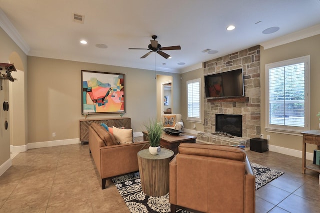 15614 Lake Iris Dr, Houston, TX 77070 - living room with crown molding, healthy amount of natural light, tile patterned floors, a stone fireplace, and a ceiling fan