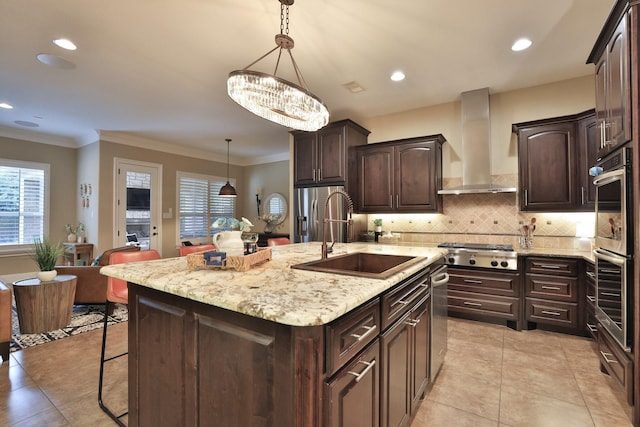 15614 Lake Iris Dr, Houston, TX 77070 - kitchen with wall chimney exhaust hood, appliances with stainless steel finishes, a breakfast bar area, a center island with sink, and dark brown cabinets