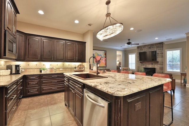 15614 Lake Iris Dr, Houston, TX 77070 - kitchen with stainless steel appliances, a kitchen bar, dark brown cabinetry, a ceiling fan, and open floor plan