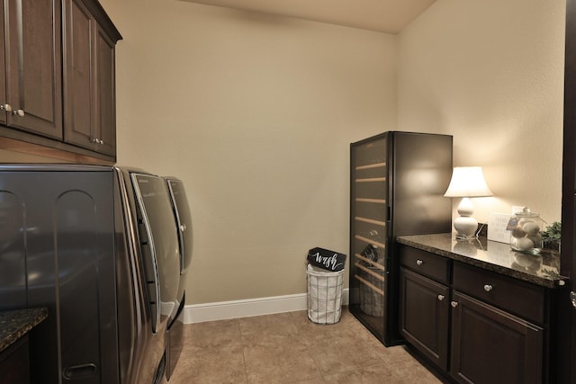 15614 Lake Iris Dr, Houston, TX 77070 - laundry room featuring cabinet space, separate washer and dryer, and light tile patterned floors