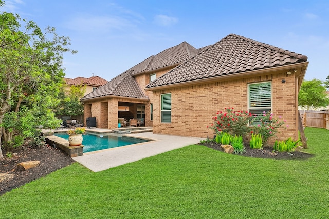 15614 Lake Iris Dr, Houston, TX 77070 - rear view of house featuring a pool with connected hot tub, brick siding, a tile roof, and a fenced backyard