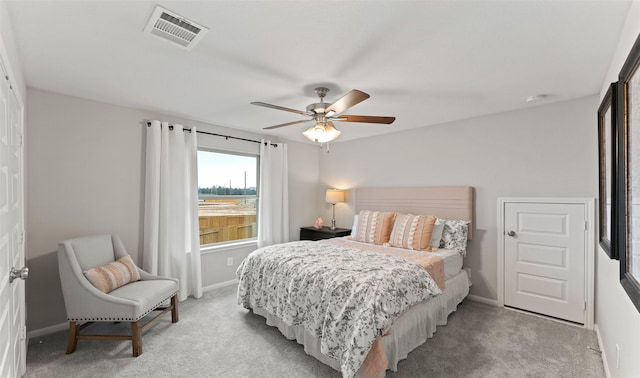 bedroom with visible vents, light carpet, and baseboards