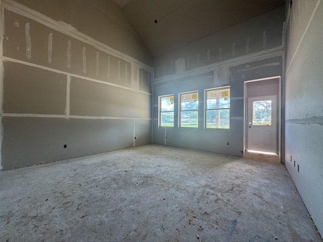 spare room with vaulted ceiling and a healthy amount of sunlight