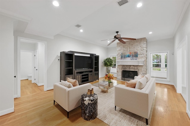 14 Wind River Dr, Conroe, TX 77384 - living room featuring light wood-style flooring, crown molding, recessed lighting, ceiling fan, and a fireplace