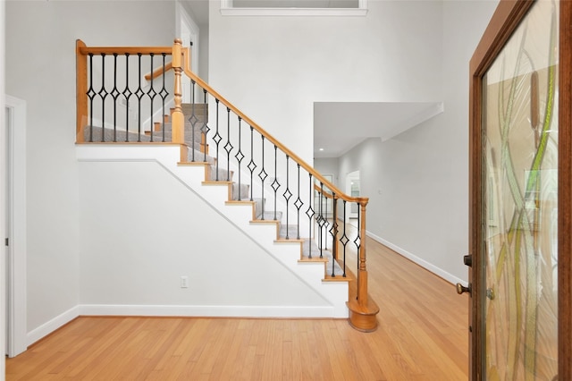 14 Wind River Dr, Conroe, TX 77384 - staircase with wood finished floors, baseboards, and a high ceiling