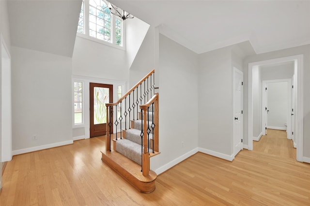 14 Wind River Dr, Conroe, TX 77384 - entryway with wood finished floors, stairs, baseboards, and a towering ceiling