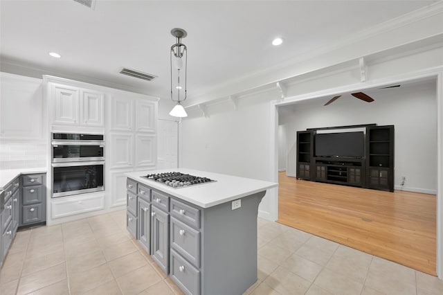 14 Wind River Dr, Conroe, TX 77384 - kitchen with gray cabinets, appliances with stainless steel finishes, light tile patterned flooring, light countertops, and recessed lighting