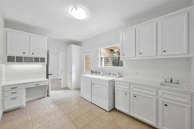 14 Wind River Dr, Conroe, TX 77384 - laundry area with washer and clothes dryer, cabinet space, and light tile patterned floors