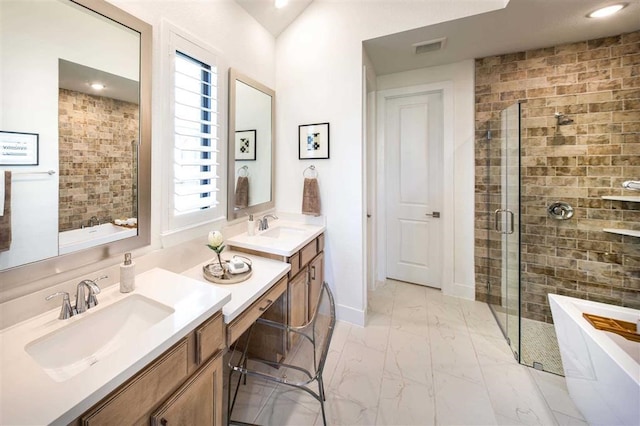 full bath featuring a freestanding tub, a shower stall, visible vents, marble finish floor, and a sink