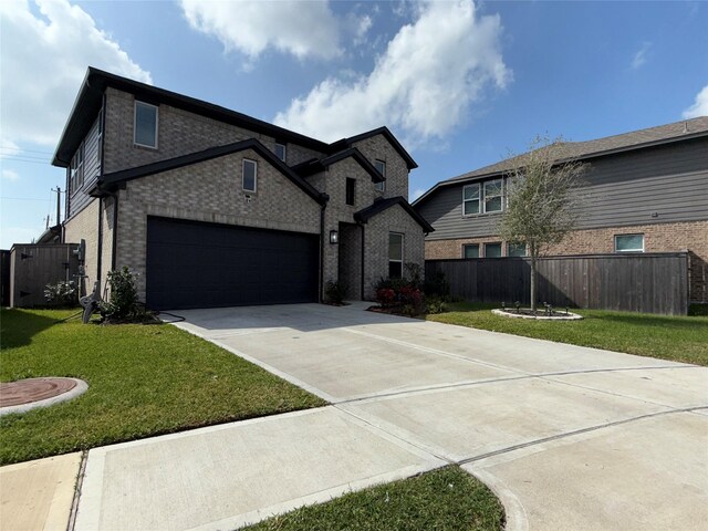 2412 Elliott Shore Ln, La Porte, TX 77571 - view of front of home featuring driveway, a garage, fence, and a front lawn
