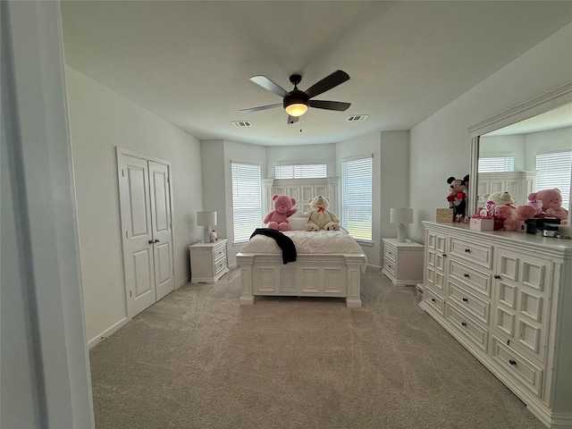2412 Elliott Shore Ln, La Porte, TX 77571 - carpeted bedroom with baseboards, visible vents, multiple windows, and a ceiling fan