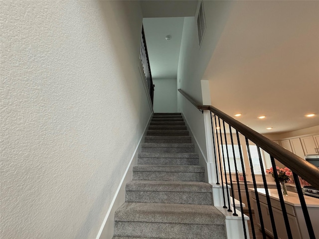 2412 Elliott Shore Ln, La Porte, TX 77571 - stairway with visible vents, a textured wall, baseboards, and recessed lighting