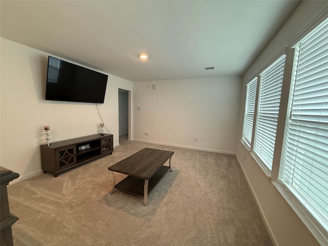 2412 Elliott Shore Ln, La Porte, TX 77571 - carpeted living area featuring baseboards and visible vents