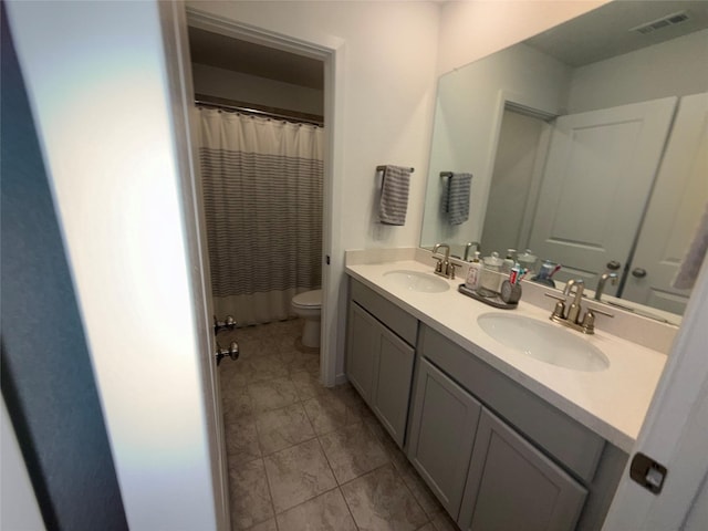 2412 Elliott Shore Ln, La Porte, TX 77571 - full bathroom with visible vents, a sink, toilet, and double vanity