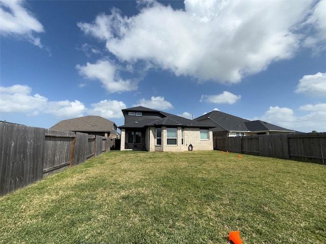 2412 Elliott Shore Ln, La Porte, TX 77571 - back of property with brick siding, a fenced backyard, and a yard