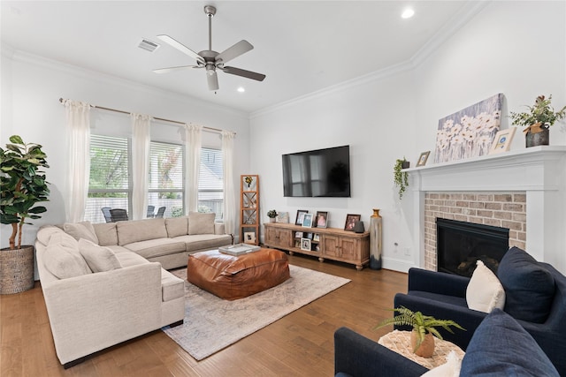106 Golden Eye Ct, Montgomery, TX 77316 - living room featuring a ceiling fan, crown molding, wood finished floors, recessed lighting, and a fireplace