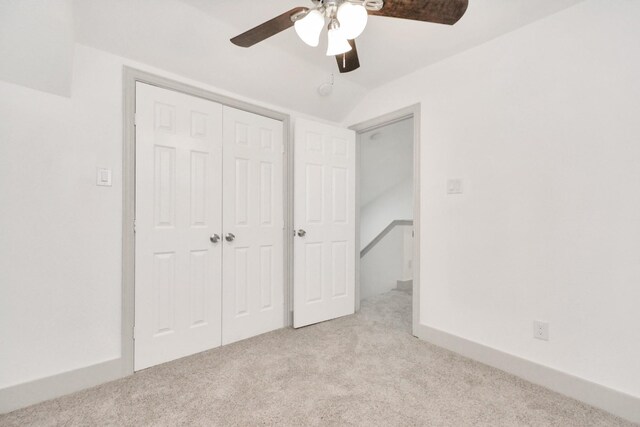 1501 Maiden Ln, Richmond, TX 77469 - unfurnished bedroom featuring a closet, baseboards, a ceiling fan, carpet floors, and vaulted ceiling