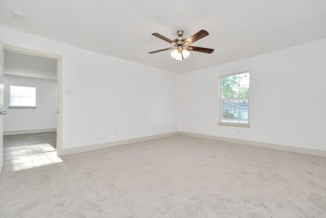 1501 Maiden Ln, Richmond, TX 77469 - spare room featuring baseboards, a ceiling fan, and light carpet
