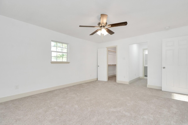1501 Maiden Ln, Richmond, TX 77469 - unfurnished bedroom featuring a closet, baseboards, ceiling fan, a spacious closet, and light colored carpet
