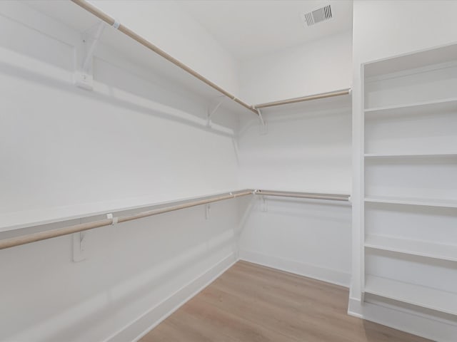 spacious closet featuring visible vents and light wood-style flooring