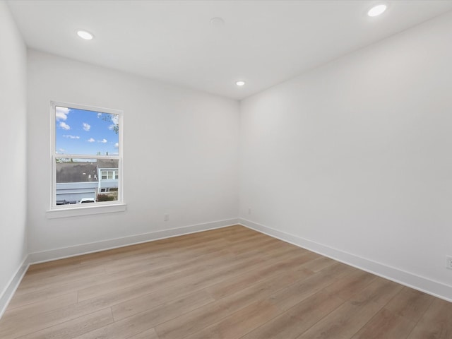 unfurnished room featuring recessed lighting, baseboards, and light wood finished floors