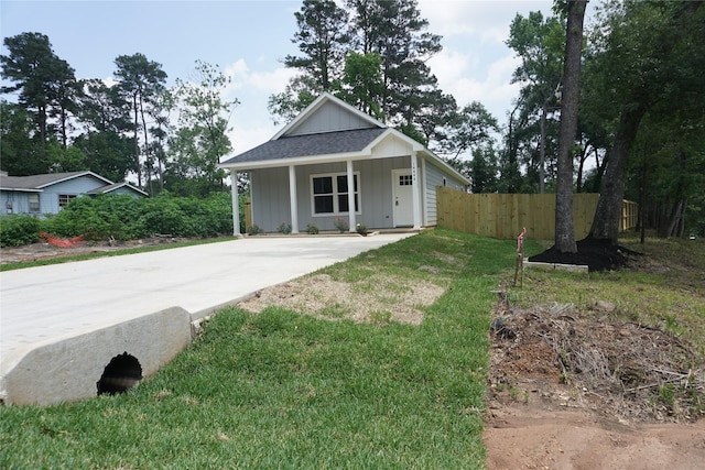 14848 Lamar Rd, Willis, TX 77378 - bungalow-style house featuring board and batten siding, fence, driveway, and covered porch