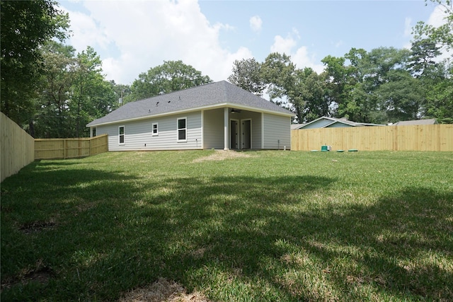 14848 Lamar Rd, Willis, TX 77378 - back of house with a fenced backyard, a ceiling fan, and a yard