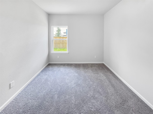 empty room with carpet flooring and baseboards
