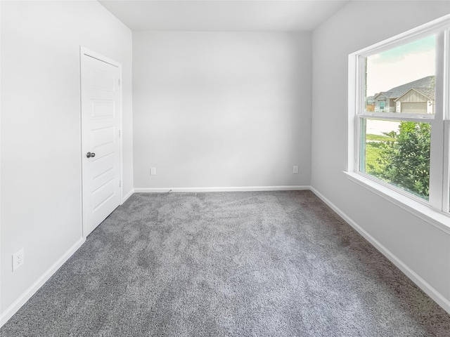 carpeted spare room with baseboards