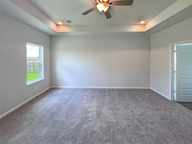 carpeted empty room featuring baseboards, a tray ceiling, ceiling fan, and recessed lighting