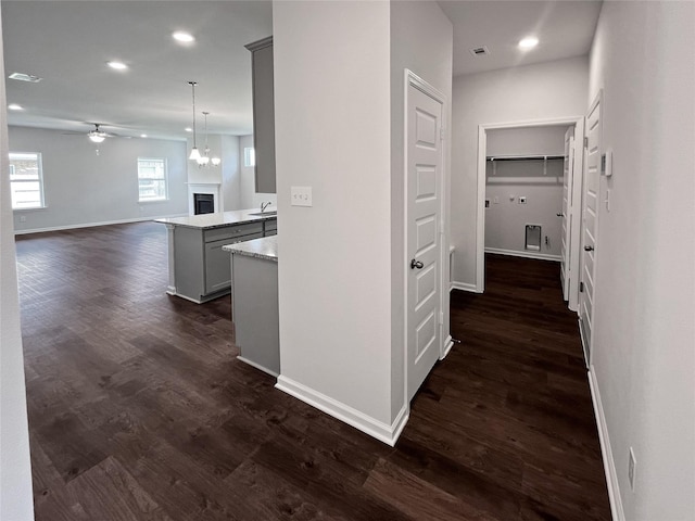 1907 Temple Grove Dr, Iowa Colony, TX 77583 - corridor with baseboards, dark wood-type flooring, a sink, and recessed lighting