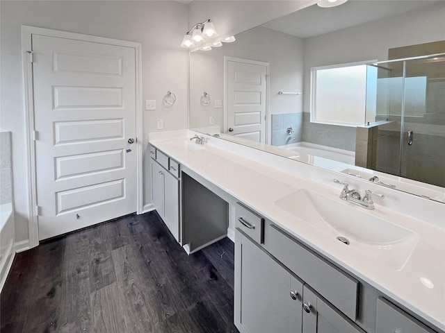 1907 Temple Grove Dr, Iowa Colony, TX 77583 - bathroom featuring a garden tub, a stall shower, double vanity, and wood finished floors