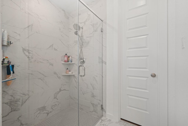 full bathroom featuring marble finish floor and a marble finish shower