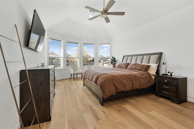 bedroom with light wood finished floors, baseboards, vaulted ceiling, and a ceiling fan