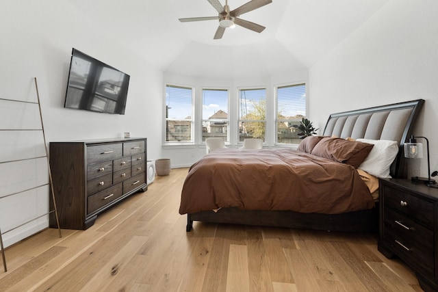 bedroom with light wood-type flooring, ceiling fan, and vaulted ceiling