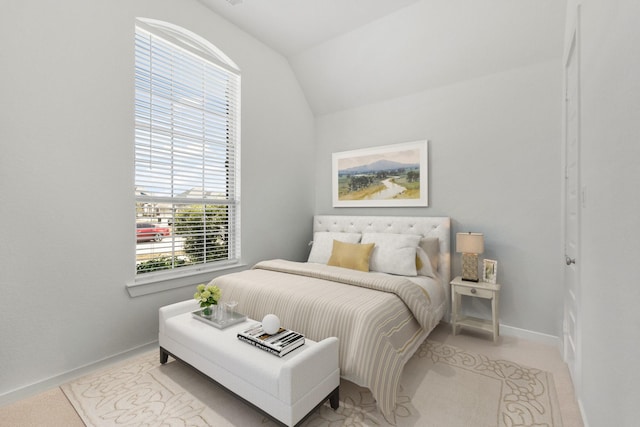 bedroom featuring baseboards and vaulted ceiling