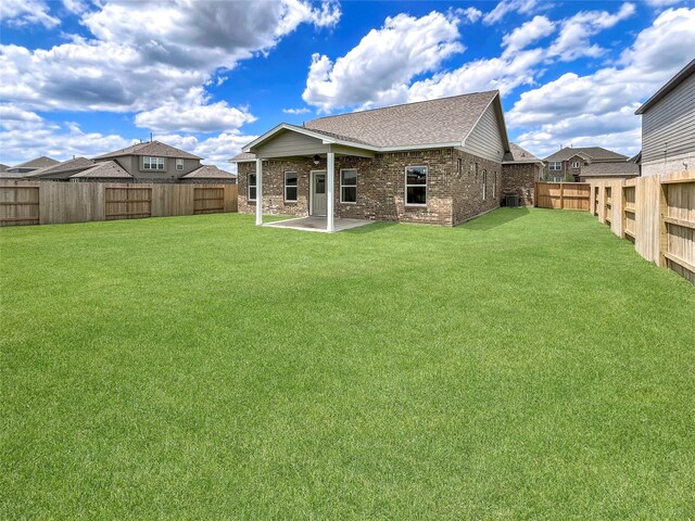 1826 Temple Grove Dr, Iowa Colony, TX 77583 - back of property featuring brick siding, a patio, roof with shingles, and central air condition unit