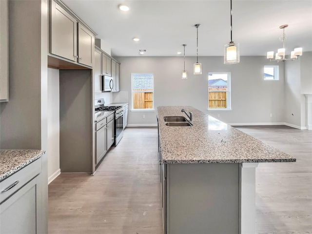 1826 Temple Grove Dr, Iowa Colony, TX 77583 - kitchen with stainless steel appliances, a sink, gray cabinets, baseboards, and recessed lighting