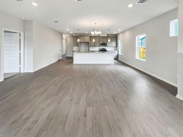1826 Temple Grove Dr, Iowa Colony, TX 77583 - unfurnished living room featuring a chandelier, baseboards, recessed lighting, and wood finished floors