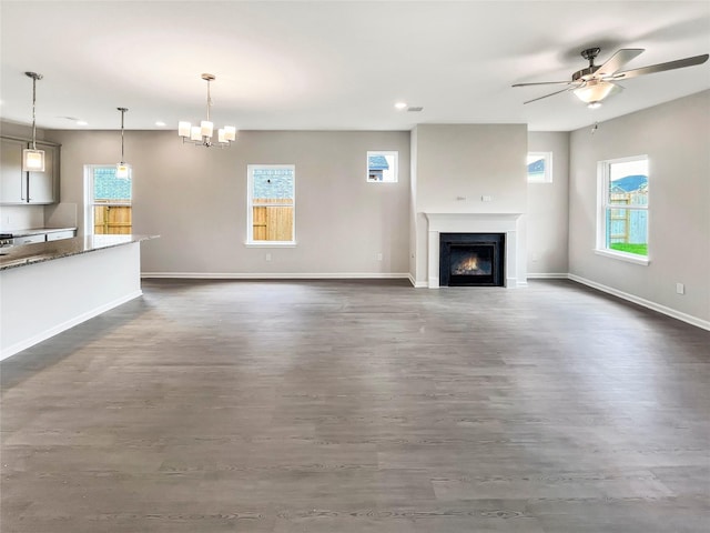 1826 Temple Grove Dr, Iowa Colony, TX 77583 - unfurnished living room with plenty of natural light, a ceiling fan, a warm lit fireplace, recessed lighting, and baseboards