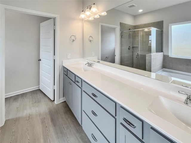 1826 Temple Grove Dr, Iowa Colony, TX 77583 - full bathroom featuring a shower stall, double vanity, wood finished floors, and a garden tub