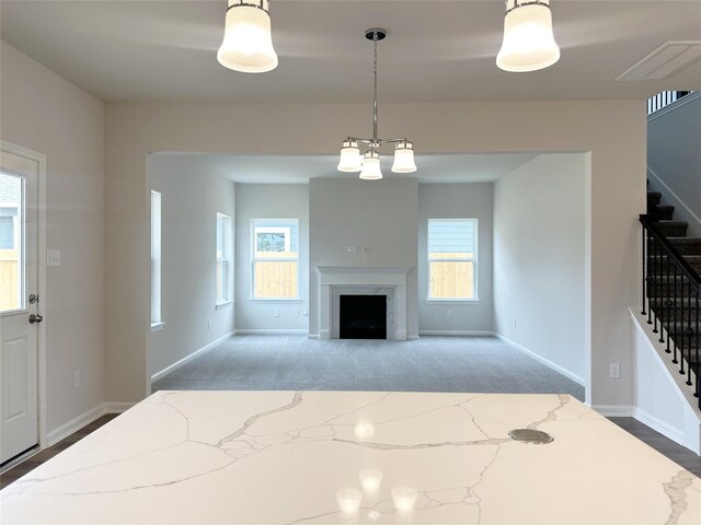 755 Red Mulberry St, La Marque, TX 77568 - unfurnished living room featuring stairs, plenty of natural light, a fireplace, and carpet flooring
