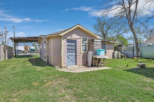 13022 Gladden Dr, Houston, TX 77049 - view of outdoor structure with a carport, an outbuilding, and fence