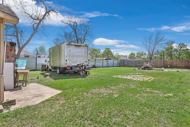 13022 Gladden Dr, Houston, TX 77049 - view of yard with a fenced backyard and an outbuilding