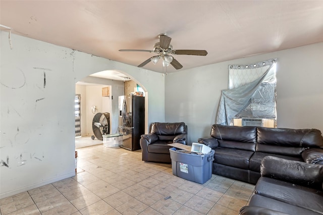 13022 Gladden Dr, Houston, TX 77049 - living room with arched walkways, ceiling fan, and baseboards