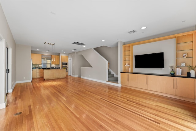 4406 Spencer St Unit A, Houston, TX 77007 - unfurnished living room with stairway, light wood-type flooring, baseboards, and recessed lighting